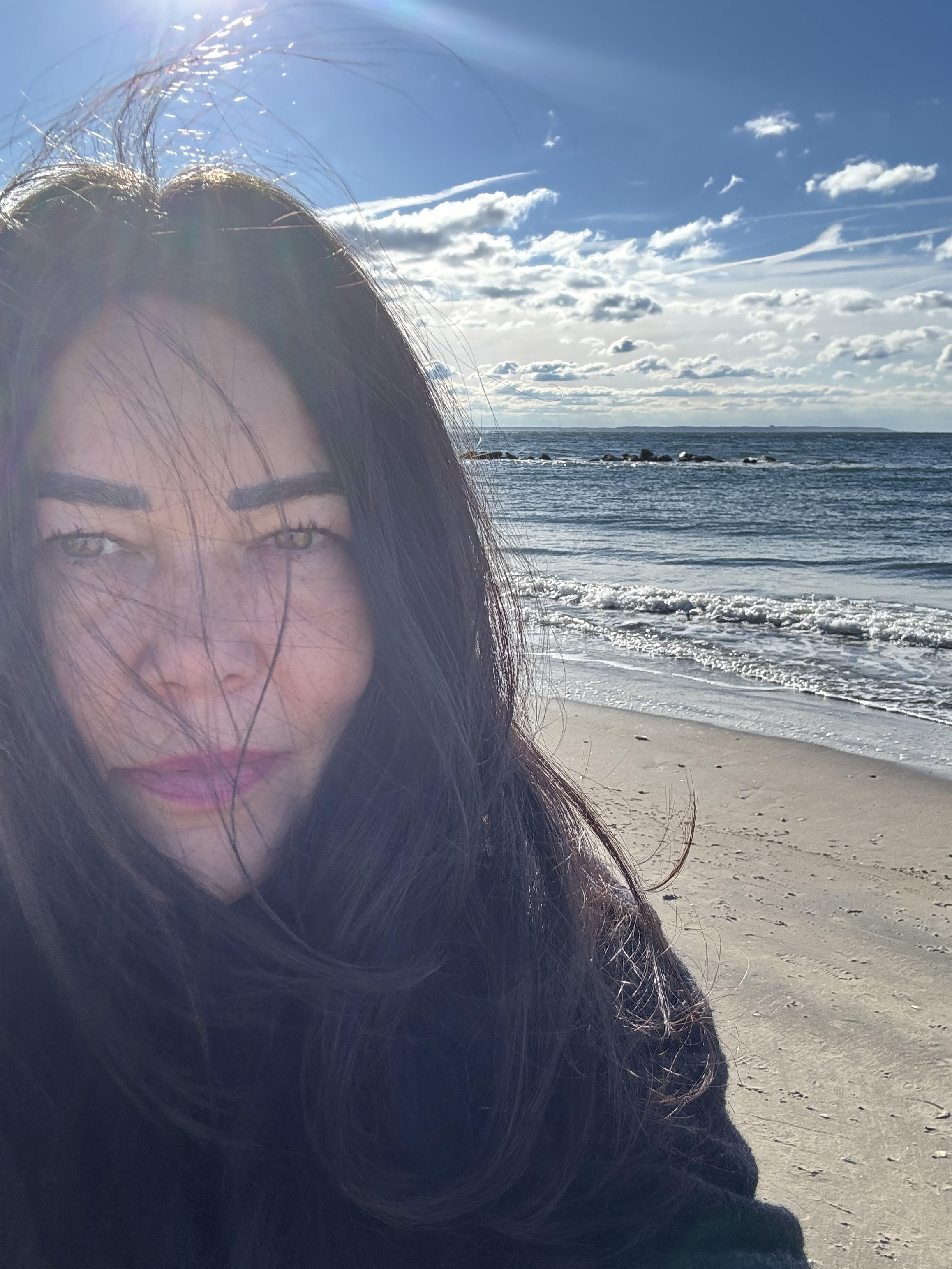 Liz enjoying nature by the ocean